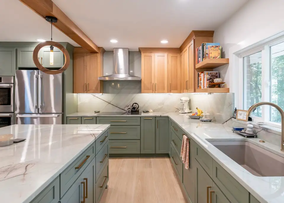 Kitchen remodeling Cleveland area project in Solon, OH: sage green shaker cabinets, wood ceiling beam, white oak open shelves and a wide island with a pendant light